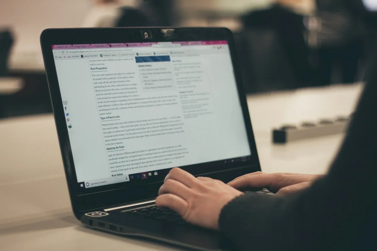 Content creator writing on laptop